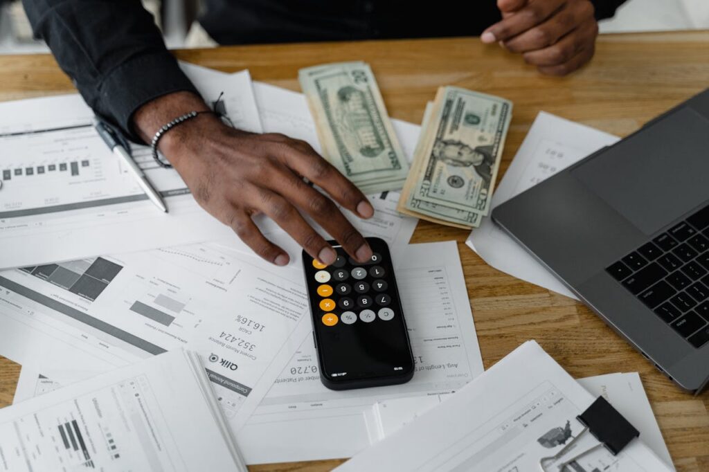Mastering the First Impression: Your intriguing post title goes here Overhead view of financial documents with calculator, cash, and laptop for financial planning.